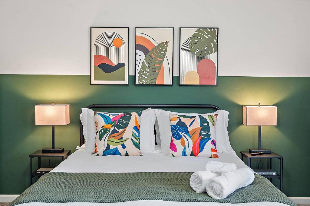 een slaapkamer met een bed met vier foto's aan de muur bij *New* Cozy / Near MTSU / Getaway ~ Sleeps 8+ in Murfreesboro