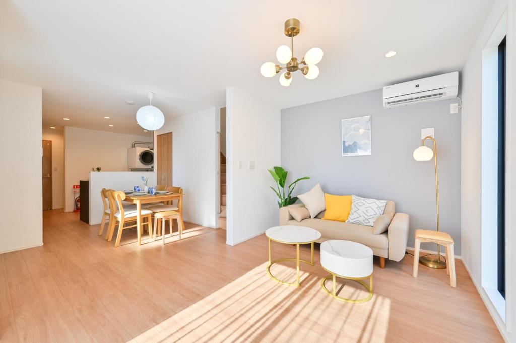a living room with a couch and a table at Hotel Tsunagari 2 in Fukuoka
