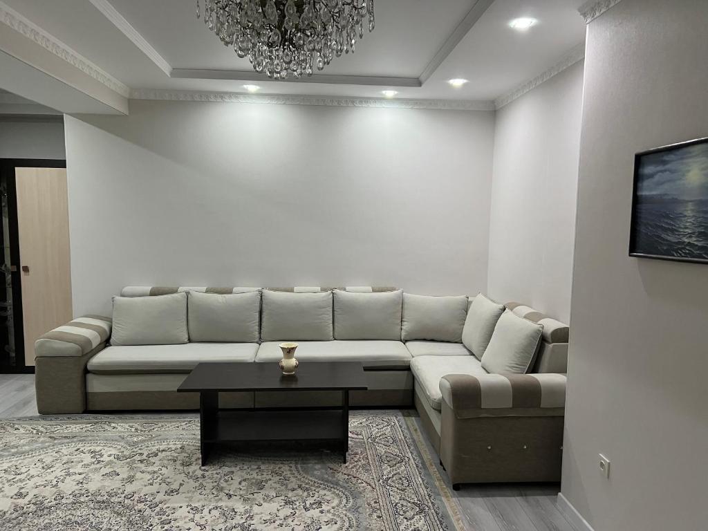 a living room with a couch and a table at Djal in Bishkek