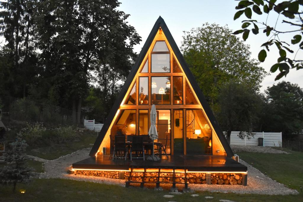 a house shaped like a triangle with a room inside at Cabana Zeneris in Vulcana de Sus