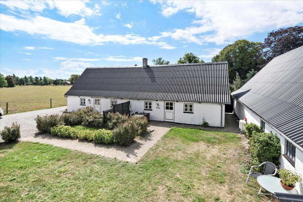 an exterior view of a white house with a yard at N159-Karrebaeksminde-Kirkebakken-40-B in Karrebæksminde