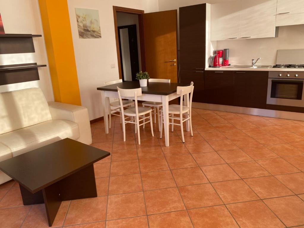 a kitchen and dining room with a table and chairs at La Fontana apartments in Fiumelatte