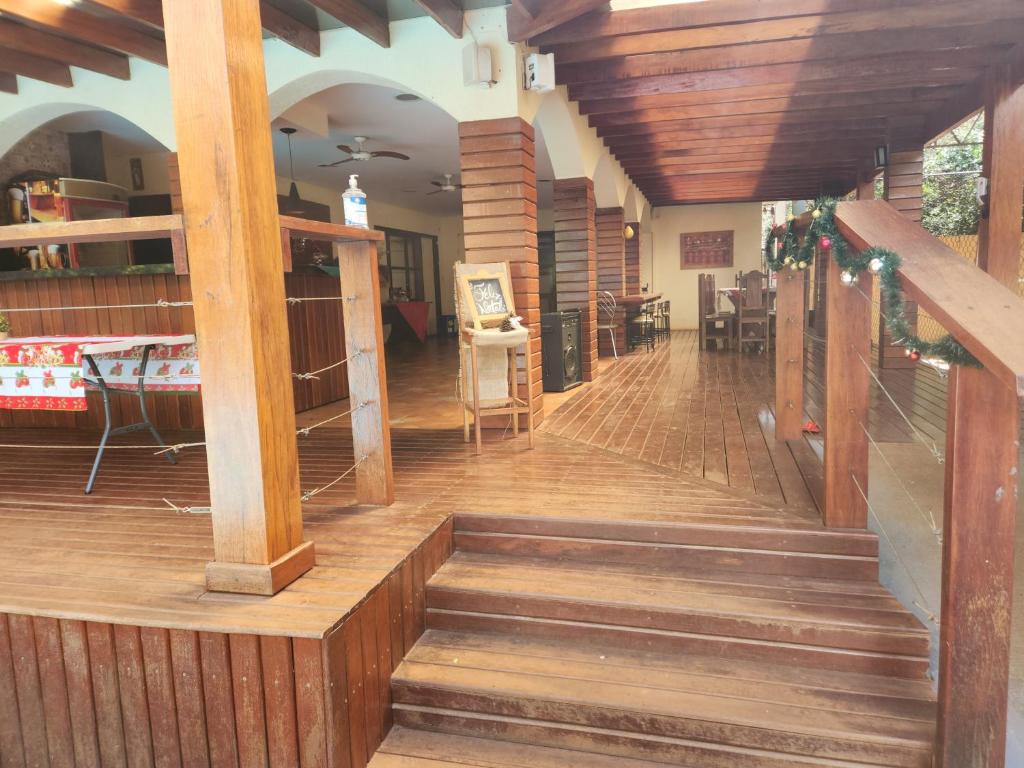 a staircase in a house with wooden floors and wooden beams at Villa Matthes in Ribeirão Preto