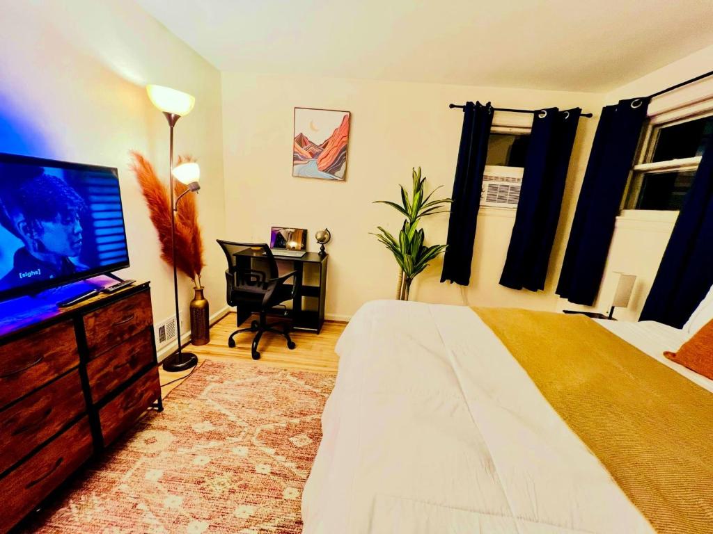 a bedroom with a bed and a flat screen tv at Comfortable Private Rooms in Rochester in Rochester