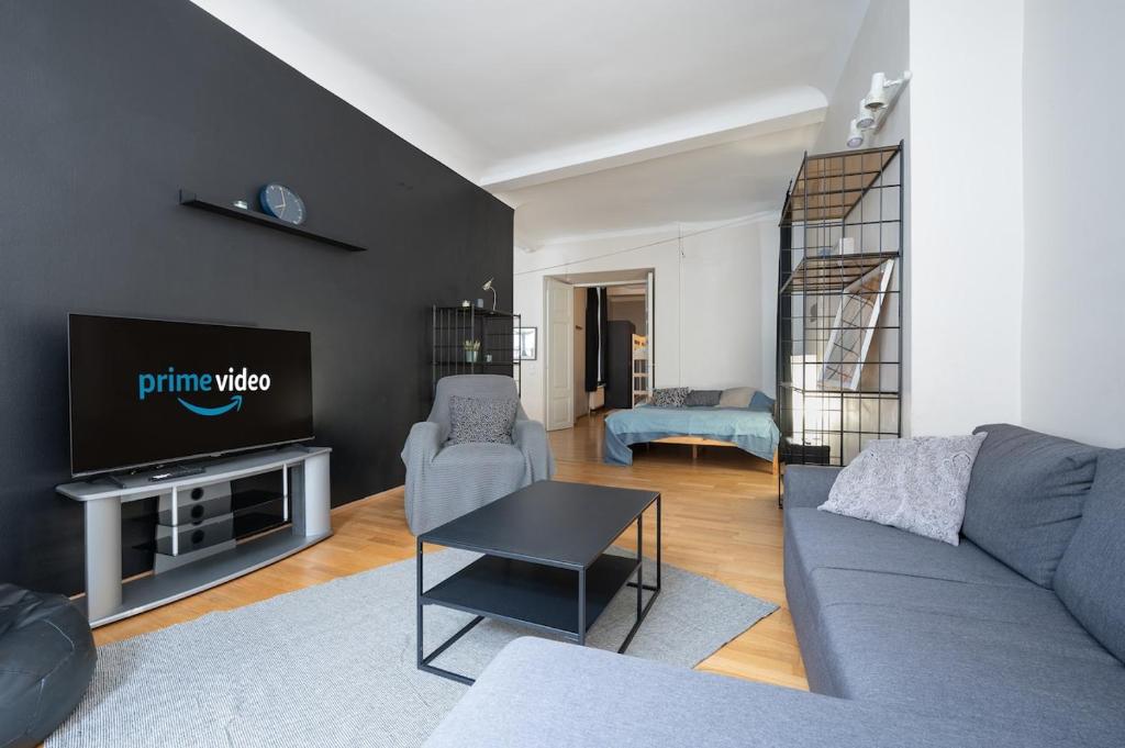 a living room with a couch and a tv at 12 guests, 70m2, center of Old Town, Wi-Fi, Streaming in Tallinn