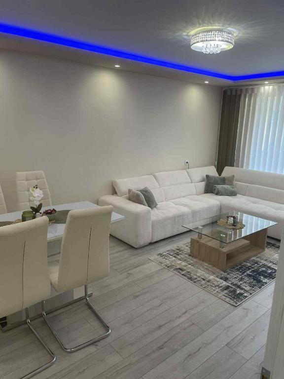 a living room with a white couch and a table at 2 Bedroom apartment in Gotse Delchev