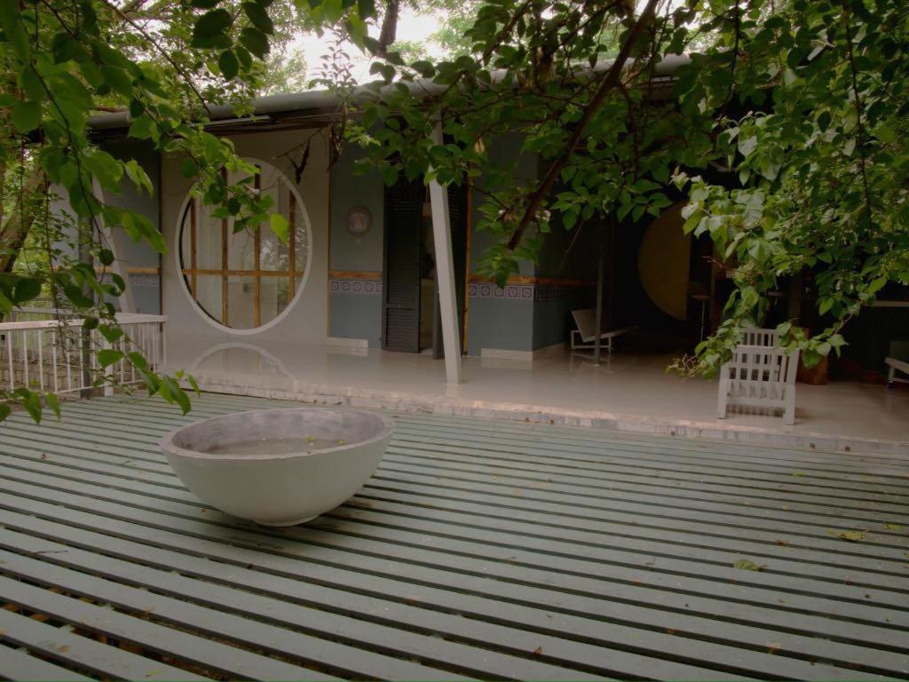 a bowl sitting on a deck in front of a house at Clear Mountains Properties in Kharakvasla