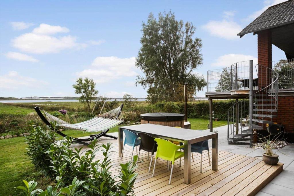a patio with chairs and a table and a hammock at JB244-Logstor-Aggersborgvej-51 in Løgstør