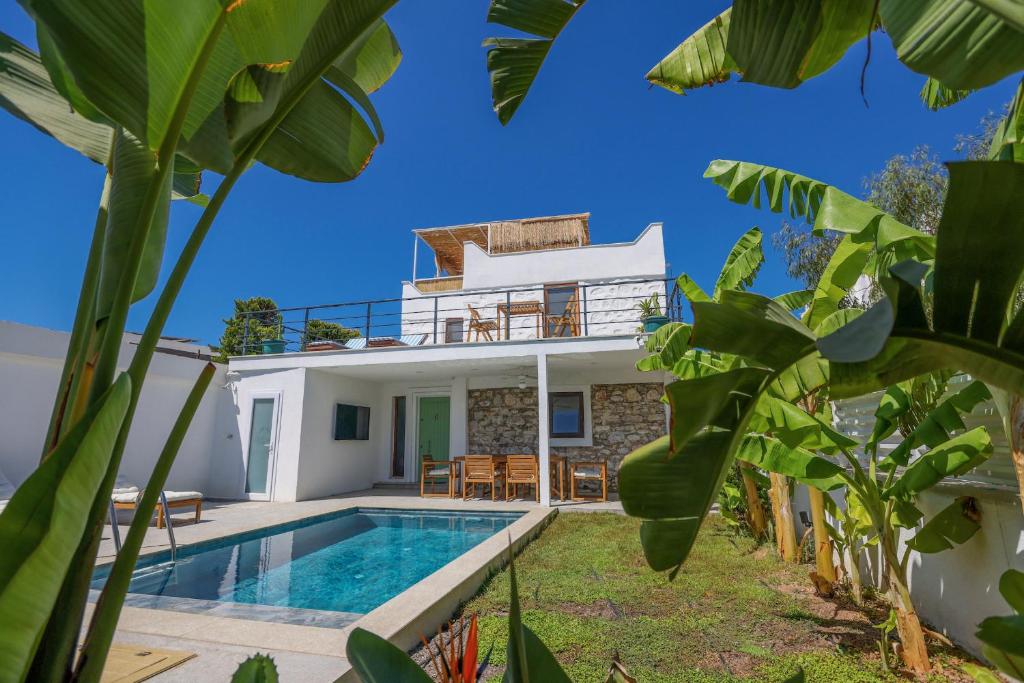 a villa with a swimming pool and a house at Traditional Seaside Stone Villa with Private Pool in Bodrum City