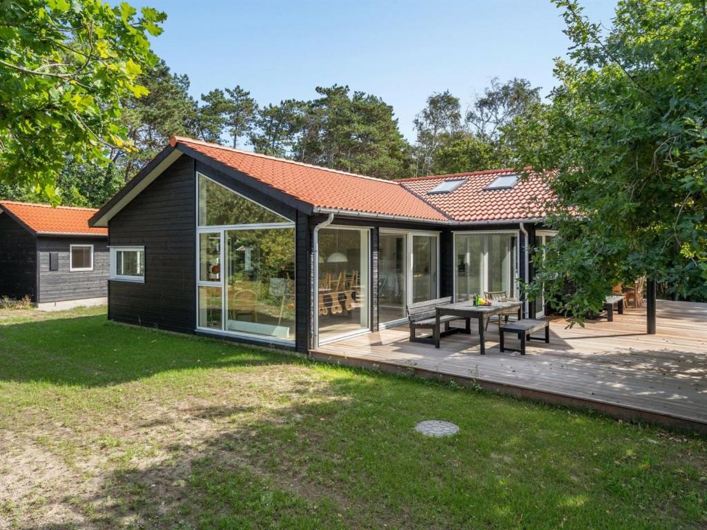 an extension of a house with glass doors and a patio at Holiday Home Efka - 175m from the sea by Interhome in Asnæs