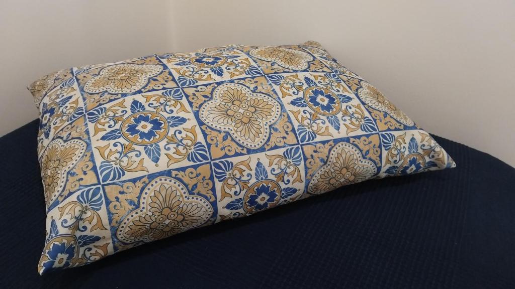 a pillow with a floral pattern on it on a bed at Leukos Home Relais Ecoretreat b&b in Diamante