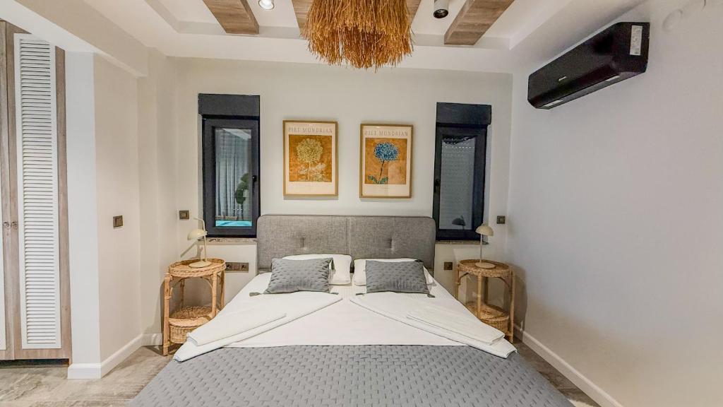 a bedroom with a bed and two chairs in it at Leos Apartments Apart1 in Side