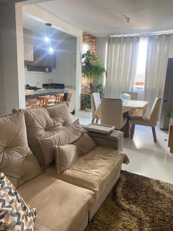 a living room with a couch and a table at Villa Zilá in Vila Velha