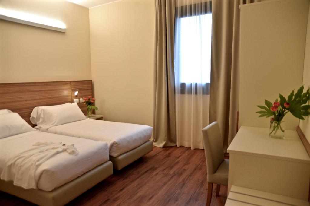 Postel nebo postele na pokoji v ubytování Hotel Forum