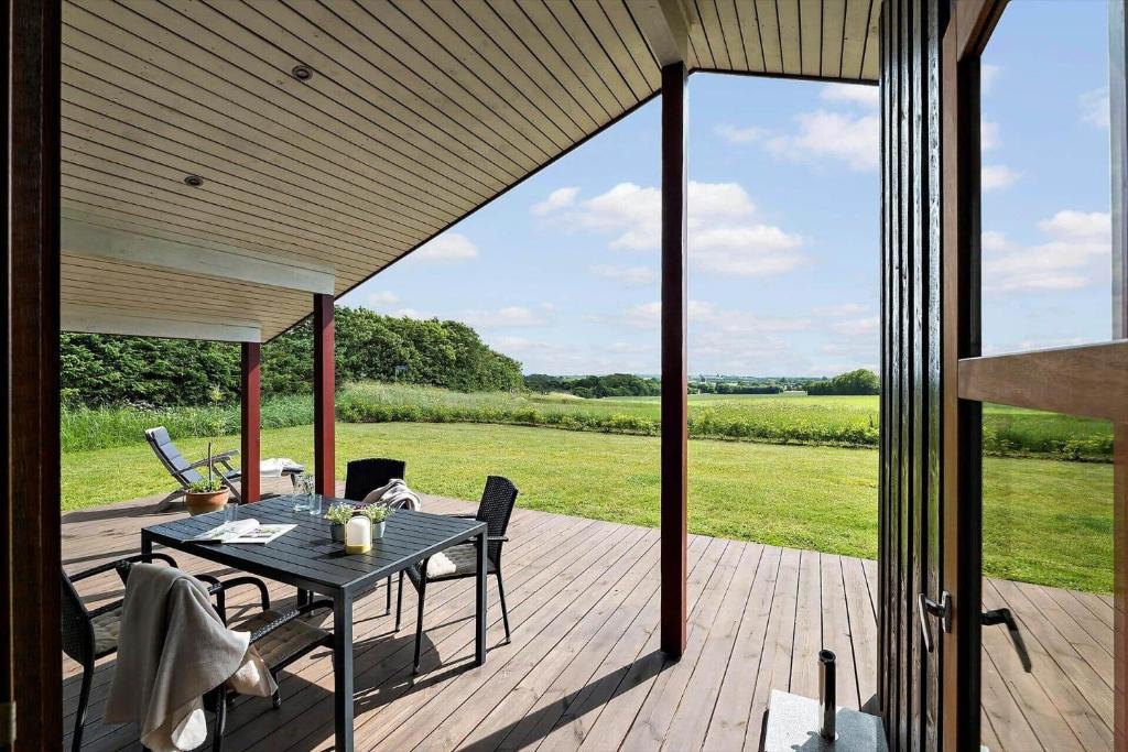 a patio with a table and chairs on a deck at JB188-Fjerritslev-Kollerup-Klitvej-163 in Fjerritslev
