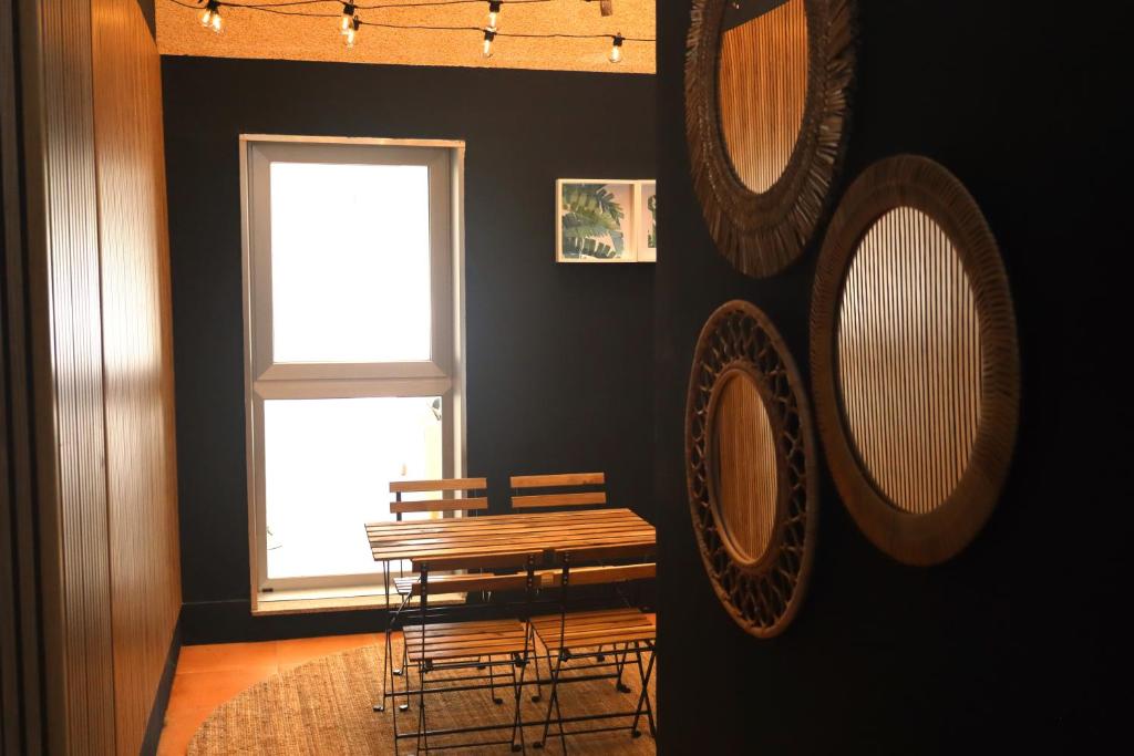 a room with a table and chairs and mirrors at Casa do Balneario in Arnoia