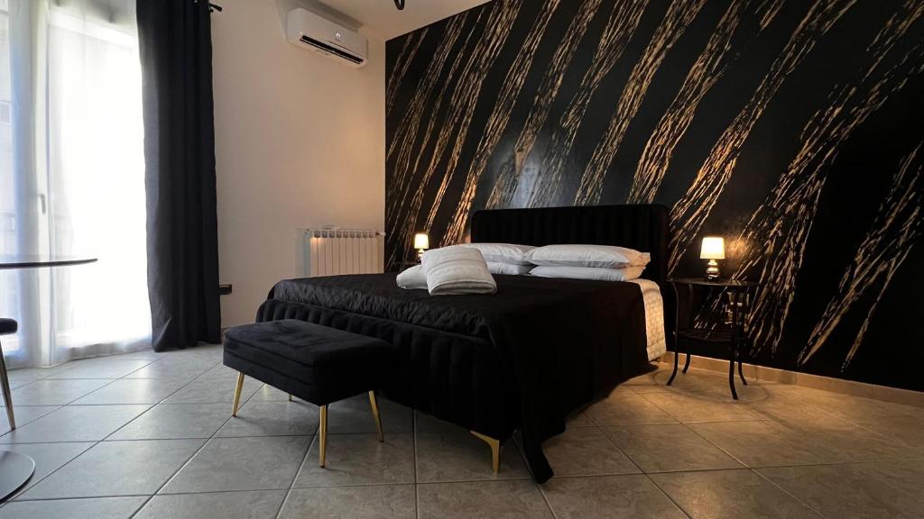 une chambre avec un lit avec un mur noir dans l'établissement Suite del Corso, à Ficarazzi