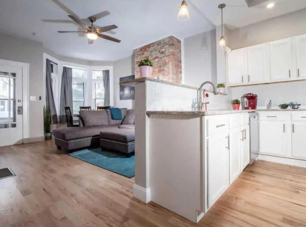 an open kitchen and living room with a couch at Highland Apartment in Columbus