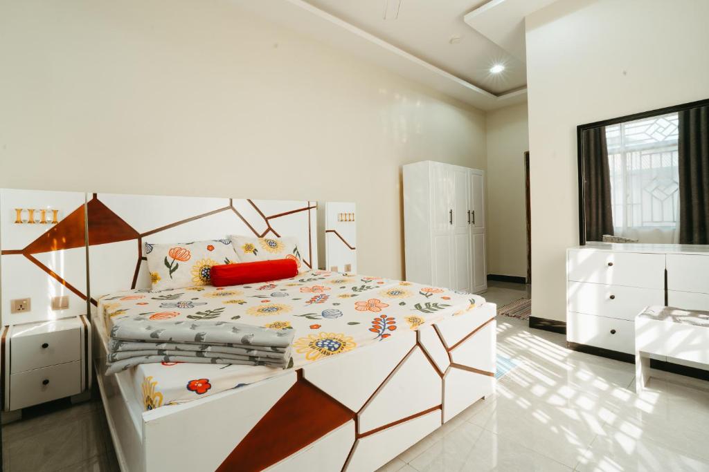 a bedroom with a large bed in a room at Entire house - full AC - beach close in Dar es Salaam