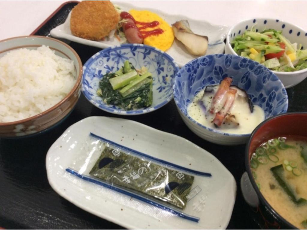 a tray of bowls of food with rice and vegetables at Hotel Tetora Hachinohe - Vacation STAY 12731v in Hitoichi