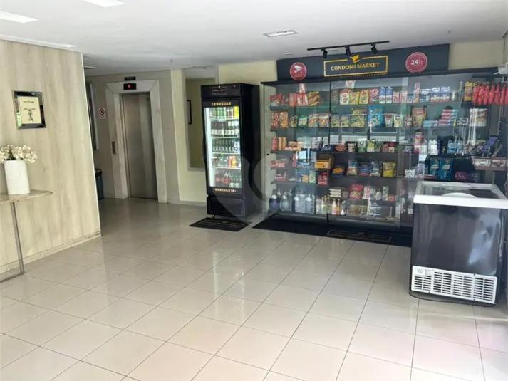 a grocery store aisle with a drink cooler in a store at Villa damasco in Fortaleza