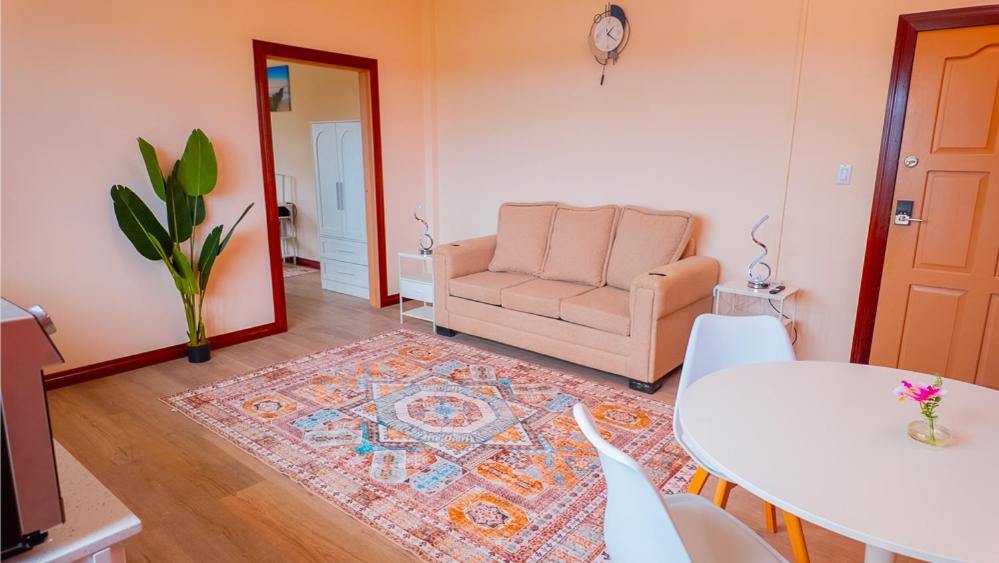 a living room with a couch and a table at MDG Suites 