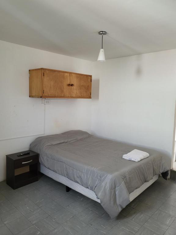 a bedroom with a bed and a cabinet on the wall at SLC San Martín 3 in San Luis