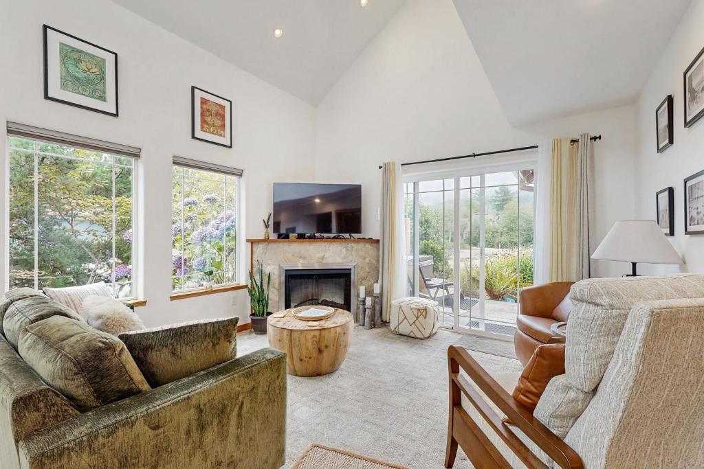 a living room with a couch and a fireplace at Spring Lake Retreat in Rockaway Beach