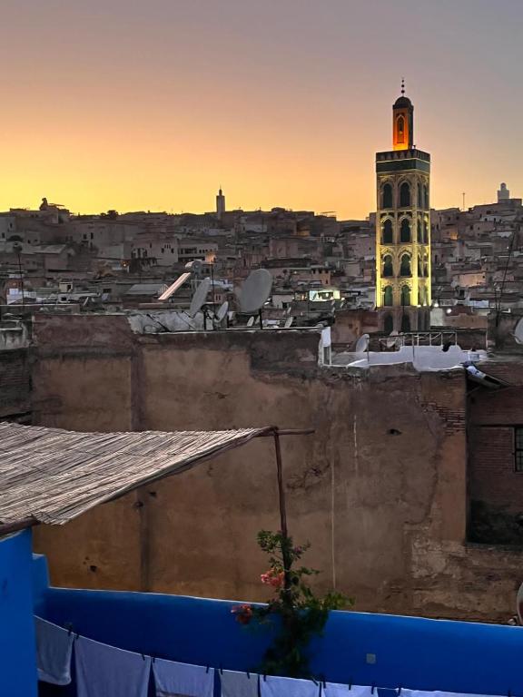 a view of a city with a clock tower at Riad La Mentha Panoramic Terrace in Fes Medina in Fez
