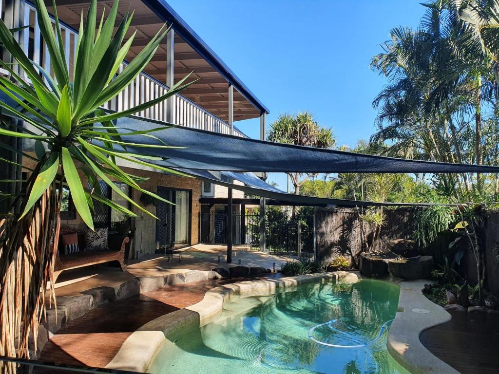 a swimming pool in the backyard of a house at Double Island Dream - Rainbow Beach in Rainbow Beach