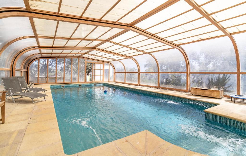 an indoor swimming pool with a glass ceiling at Gorgeous Home In Atarfe in Caparacena