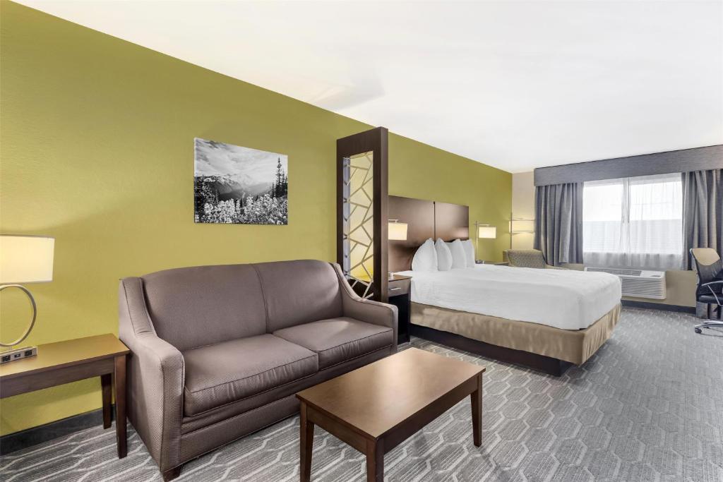 a hotel room with a bed and a couch at Best Western Plus Wenatchee Downtown Hotel in Wenatchee