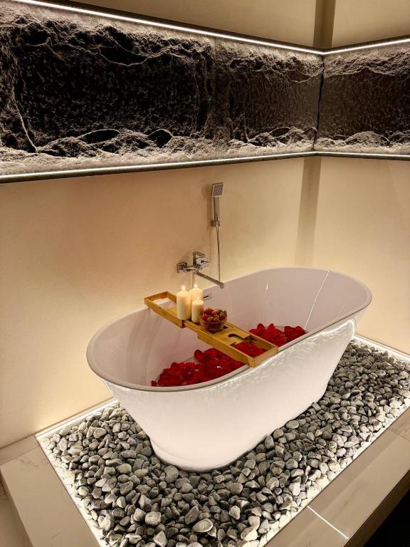 a bathroom with a bath tub with candles in it at Wot Luxury Silver Center in Arad