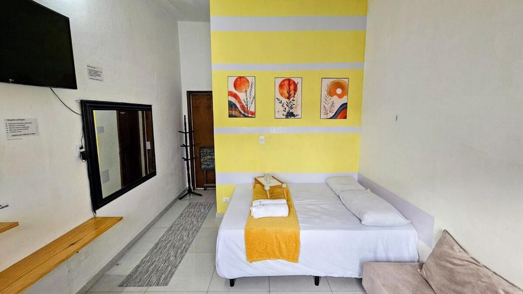 a small room with a bed and a tv at Suite 1 - Centro de Convenções700m, AC, WIFI in Recife
