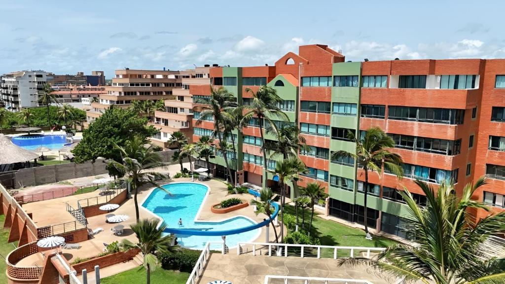 an aerial view of a resort with a swimming pool at Cozy and Relaxing Oceanfront Apartment in Tucacas