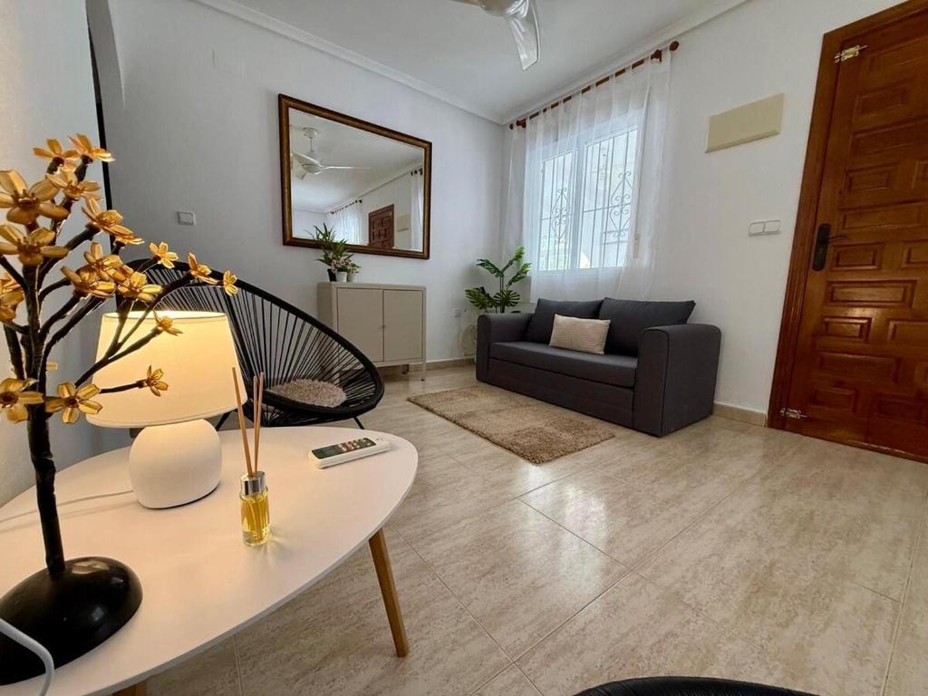 a living room with a table and a couch at Camposol Villa Mazarron, Spain in Mazarrón