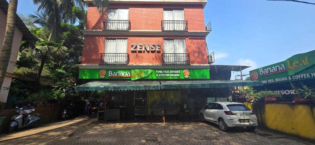 a building with a car parked in front of it at Zense Candolim in Candolim