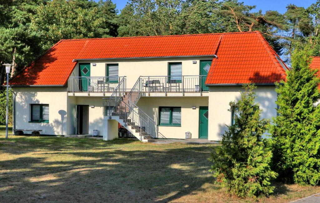 a white house with an orange roof at 3 Bedroom Awesome Apartment In Altenkirchen in Altenkirchen