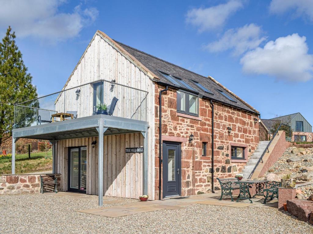 an old brick building with a glass roof at The Old Mill in Fettercairn