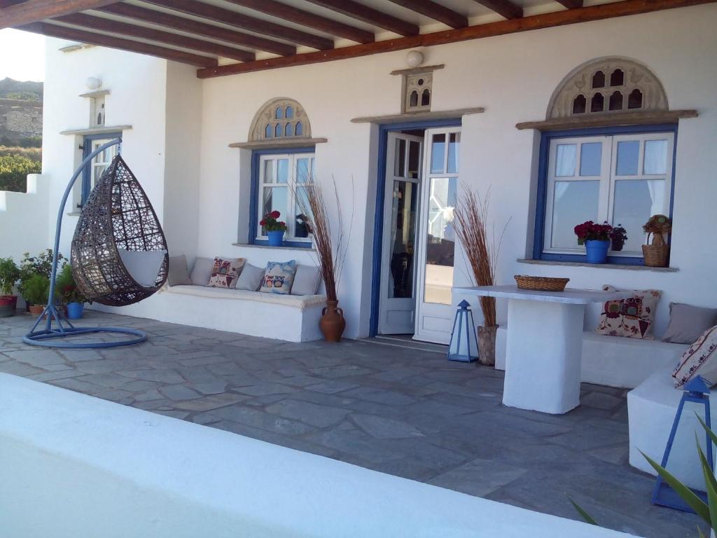 a patio of a house with a bench and windows at Balcony to the Aegean in Stení