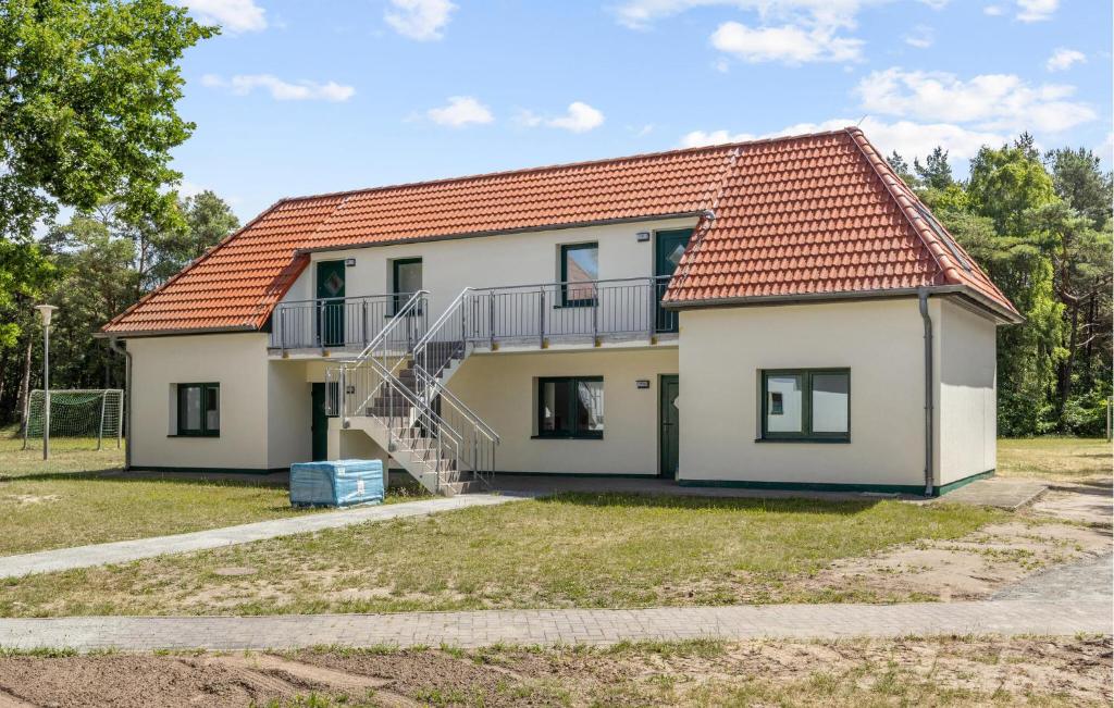 a house with a staircase in front of it at Amazing Apartment In Altenkirchen With Wifi in Altenkirchen