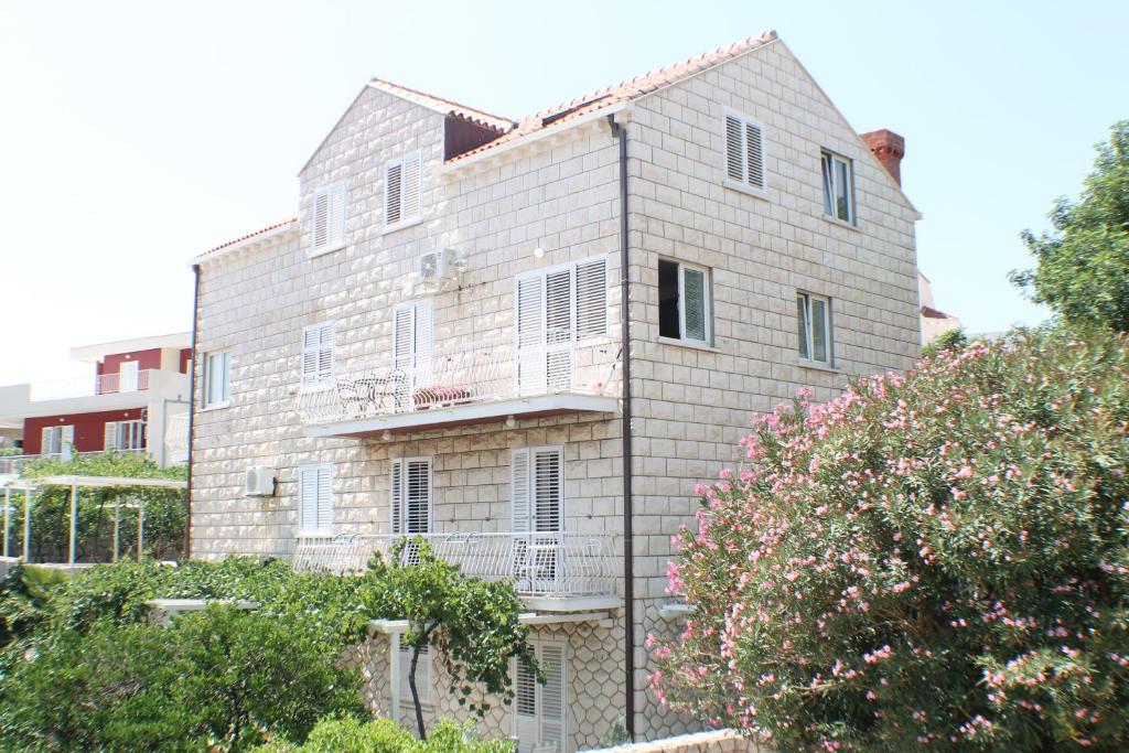 a large brick building with a balcony at Villa Jozefina in Dubrovnik