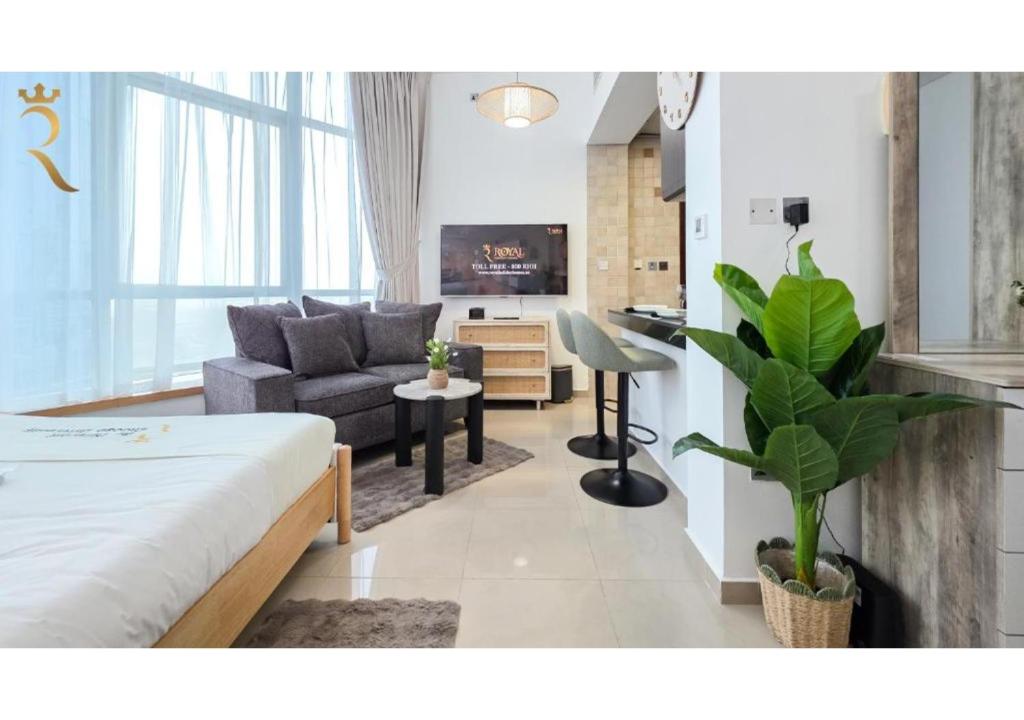 ein Wohnzimmer mit Sofa und Fernseher in der Unterkunft Al Reef Modern Escape -Sleek, Sunny & Serene in Abu Dhabi