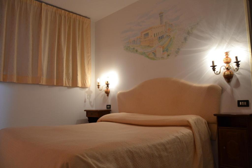 Postel nebo postele na pokoji v ubytování Hotel Ristorante Bagnaia