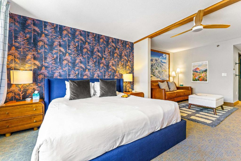 a bedroom with a large bed with a blue wall at Perfect Location Hot Tub Heated Pool Steam Room Gym in Mount Crested Butte