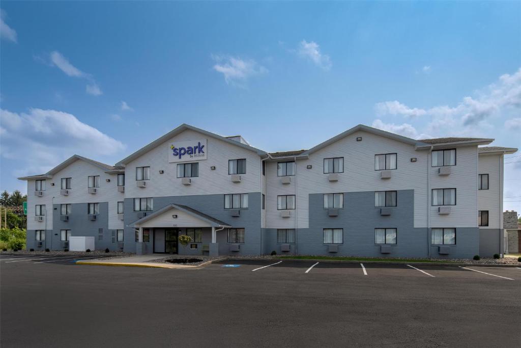 a large apartment building with a parking lot at Spark by Hilton Carlisle South in Carlisle