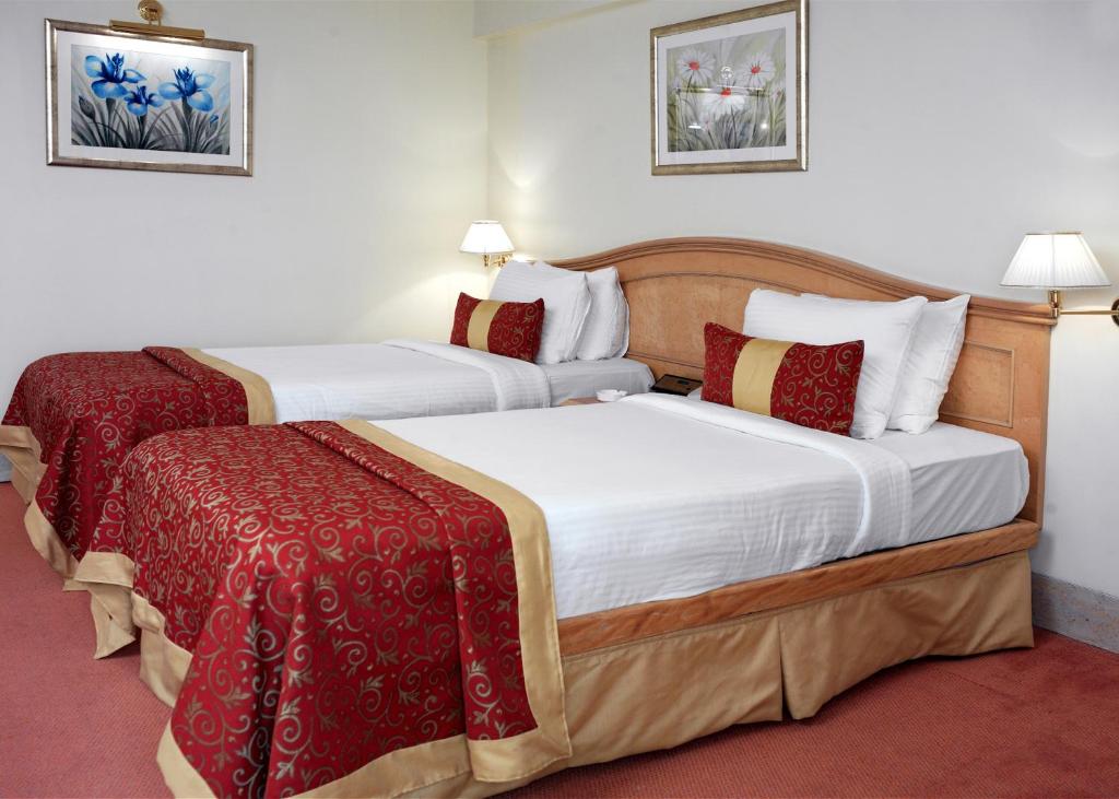 Postel nebo postele na pokoji v ubytování Ramada Plaza By Wyndham Palm Grove