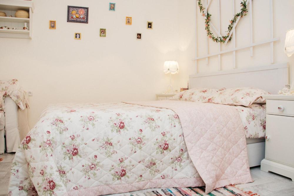 a bedroom with a bed with a pink blanket at Romantic apartment near Opera with Air-conditioning in Lviv