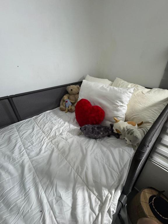 a group of stuffed animals sitting on a bed at Cozy nature homestay in Kuala Lumpur