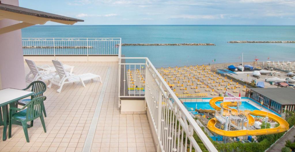 Elle comprend un balcon offrant une vue sur la piscine et l'océan. dans l'établissement Residence Hotel Amalfi, à Lido di Savio